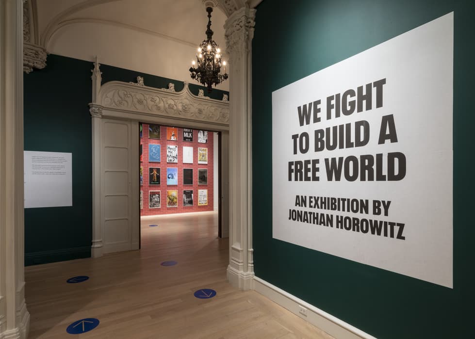 Entrance to exhibition with a large wall graphic reading 