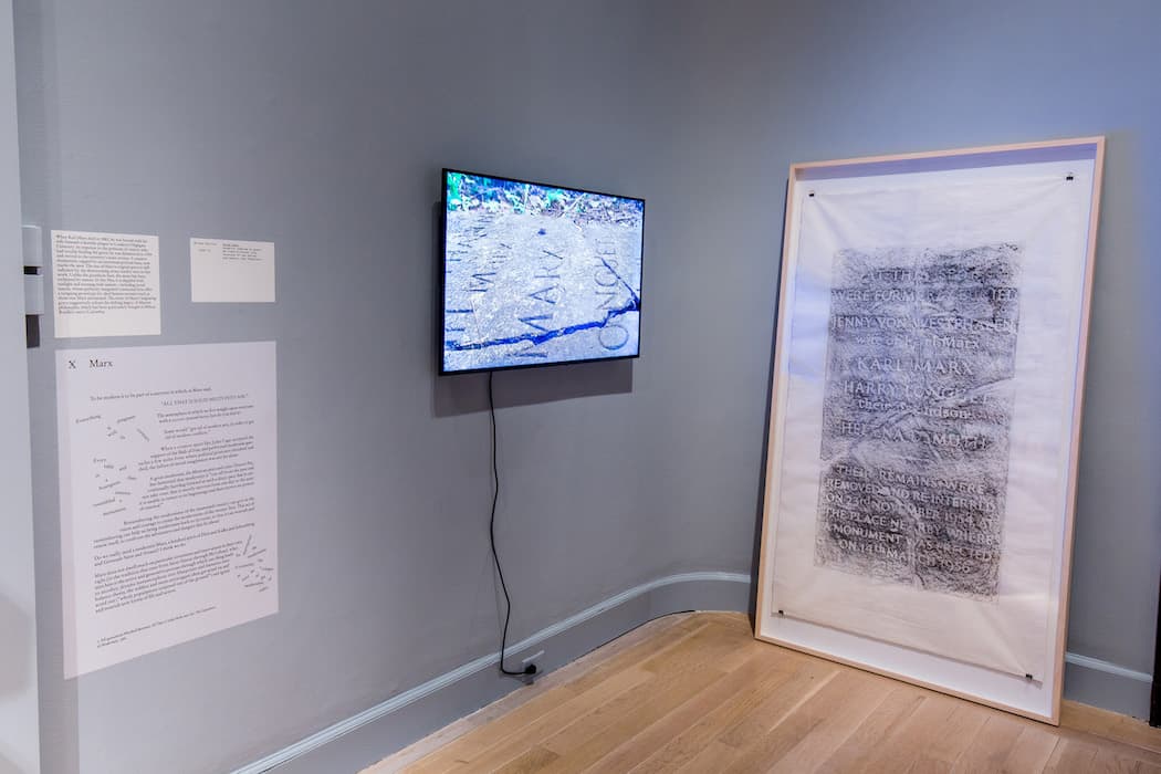 X MARX

Milena Bonilla
Stone Deaf, 2009–10
Graphite rubbing on paper, HD video 5-minute loop Courtesy of the artist and Kadist, San Francisco

When Karl Marx died in 1883, he was buried with his wife beneath a humble plaque in London’s Highgate Cemetery. In response to the petitions of visitors who had trouble finding the grave, he was disinterred in 1954 and moved to the cemetery’s main avenue. A massive monument, capped by an enormous portrait bust, now marks the spot. The site of Marx’s original grave is still indicated by the deteriorating stone marker seen in this work. Unlike the grandiose bust, the stone has been reclaimed by nature. In this film, it is dappled with sunlight and teeming with insects—including social insects, whose perfectly integrated communal lives offer a tempting prototype for ideal human societies such as those that Marx envisioned. The story of Marx’s migrating grave suggestively echoes the shifting legacy of Marxist philosophy, which has been particularly fraught in Milena Bonilla’s native Colombia.