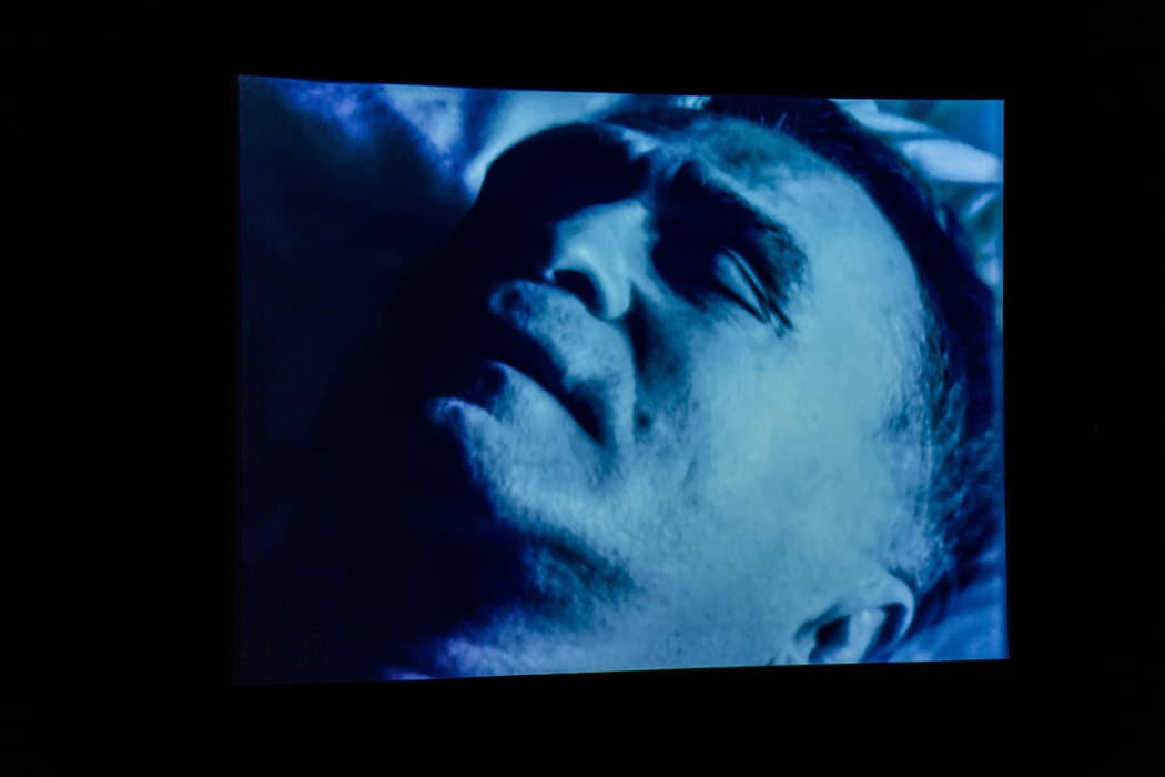 m IDLENESS 

Pierre Huyghe, Sleeptalking, 1998
Projection of super 16mm black-and-white film, transferred to video, sound
Courtesy of the artist and Marian Goodman Gallery, New York

In the nineteenth century, with the rise of the bourgeoisie and changes to the lives of the working class, more and more people had time to spend outside of work and money beyond what was needed to meet basic needs. Sports, concerts, theater, and inexpensive travel all became accessible to much of the population.

Leisure time, however, is defined and delimited by work time. In 1995 Pierre Huyghe founded the Association des Temps Libérés (Association of Freed Time), a gesture aimed at recovering unrestricted time. The project is aligned with Benjamin’s conception of idleness as fruitful and valuable, epitomized by the insightful, endlessly strolling flâneur.

Sleeptalking blends footage from Andy Warhol’s 1963 film Sleep with a voice-over and footage of the poet John Giorno reminiscing about his life in a community of artists in New York in the 1960s and 1970s. Ribald, dreamy, and exuberant, Giorno’s rambling narrative paints a picture of a kind of utopia, inhabited by people whose art was born of idleness.