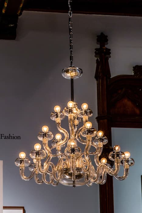 T MODES OF LIGHTING 

Cerith Wyn Evans, Astro-photography by Siegfried Marx (1987), 2006
Chandelier (Barovier and Toso), Morse-code unit, computer
Collection of Susan and Steven Jacobson, New York

One of the most profound changes to the streetscape of nineteenth-century Paris was the introduction of gas lamps, which were used in the arcades as early as the 1820s; Benjamin’s sources in Convolute T describe the impact of artificial lighting on the city. In this work, an elegant chandelier blinks this text in Morse code:

With the advent of radio astronomy in the early 1960s, techniques for the mapping of space made enormous technological advances. New findings were applied to existing data, and it was discovered that within maps charting vast swathe of the Southern Hemisphere, astral bodies— stimated to be millions of light years away—had been erroneously named and catalogued after microscopic inconsistencies within photographic emulsion. Solar systems identified from particles of dust, galaxies from dandruff.