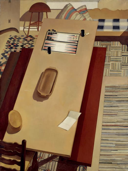 Top-down view of a table with a backgammon board, two cups, and bowls, surrounded by patterned rugs, chairs, and pillows in a domestic interior.