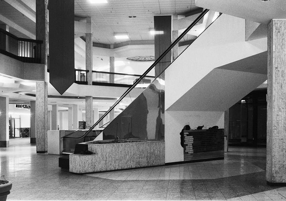 A ARCADES, MAGASINS DE NOUVEAUTÉS, SALES CLERKS

Walead Beshty, American Passages, 2001–11
Slide projection
Courtesy of the artist and Regen Projects, Los Angeles

Benjamin saw the Parisian arcades, one of the subjects of Convolute A, as emblematic of a societal mindset that typified nineteenth-century Paris and, by extension, modernity as a whole. Today’s shopping mall, the heir of the arcade, is equally emblematic of the cultural milieu that produced it—namely, the car—commuting suburbs that proliferated across America in the twentieth century. By the time Benjamin began to compile his text, many of the hundreds of arcades that once dotted Paris had been destroyed, and those that remained were dilapidated. Walead Beshty’s melancholic photographs of abandoned shopping malls suggest the decline of a way of life.