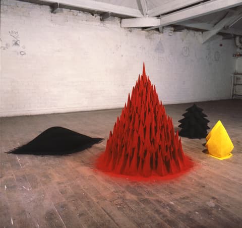 Anish Kapoor, “White Sand, Red Millet, Many Flowers,” 1982, mixed media, pigment. Dimensions variable. Arts Council Collection, Southbank Centre, London. © Anish Kapoor. All Rights Reserved, DACS, London/ ARS, NY 2025.